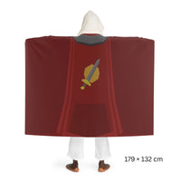 Hooded sherpa fleece blanket featuring the Attack skillcape design from Old School RuneScape, shown from the back as a cozy OSRS merch blanket and gamer gift