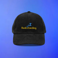 Black corduroy OSRS cap with “bankstanding” embroidery and Zzz detail, inspired by idle time at the bank in Old School RuneScape.