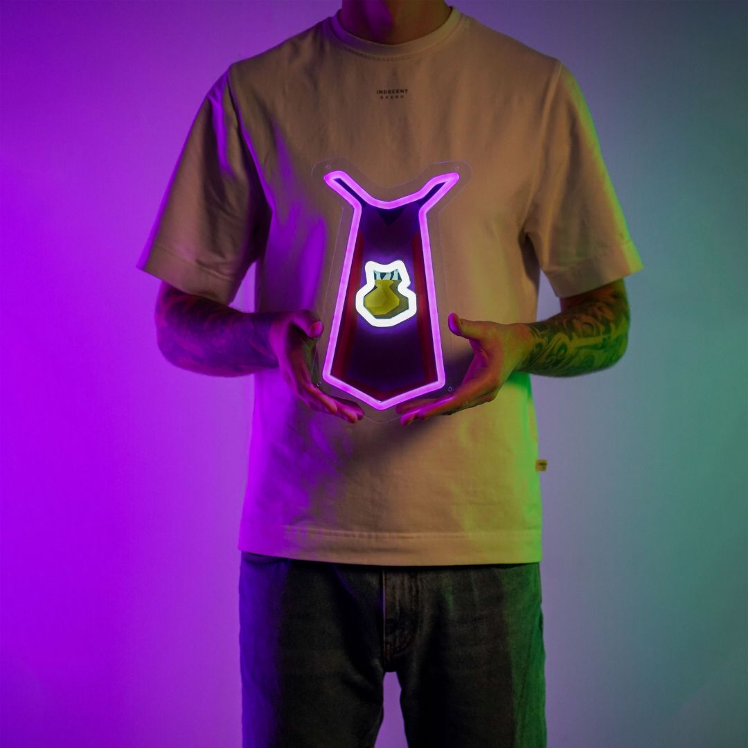 A person proudly holds the Runescape Cooking Cape LED neon sign, showcasing the iconic cooking pot symbol from the game. This LED neon sign celebrates the culinary adventures of RuneScape players, radiating a sense of pride and accomplishment.