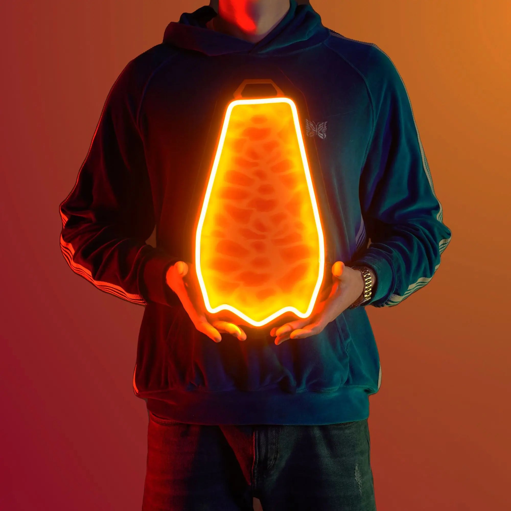 A person proudly showcases the Runescape Fire Cape LED neon sign, featuring the iconic Fire Cape design from the game. This LED neon sign symbolizes achievement and victory in RuneScape, making it an ideal addition to any gaming space. A nostalgic and unique gift for Runescape enthusiasts.