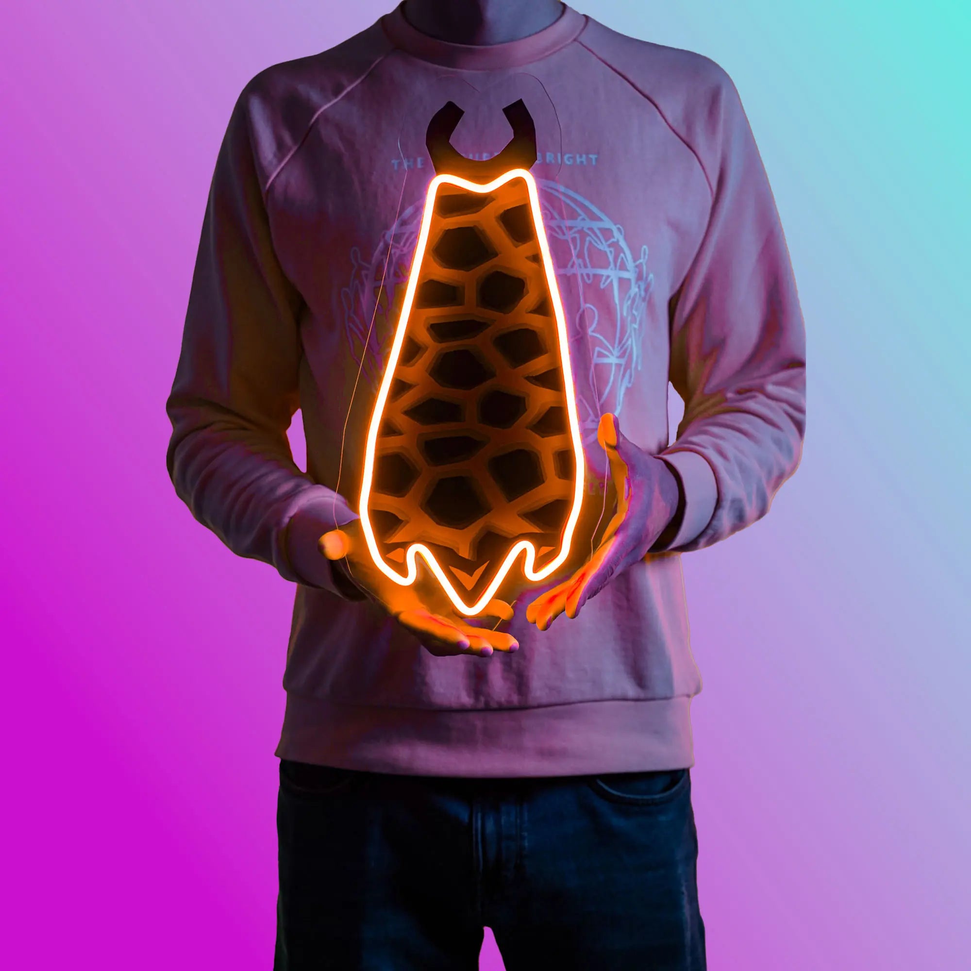 A person proudly displays the Runescape Infernal Cape LED neon sign, featuring the iconic Infernal Cape from the game. This LED neon sign represents the pinnacle of achievement in Old School RuneScape. A prestigious and nostalgic gift for RS enthusiasts. 