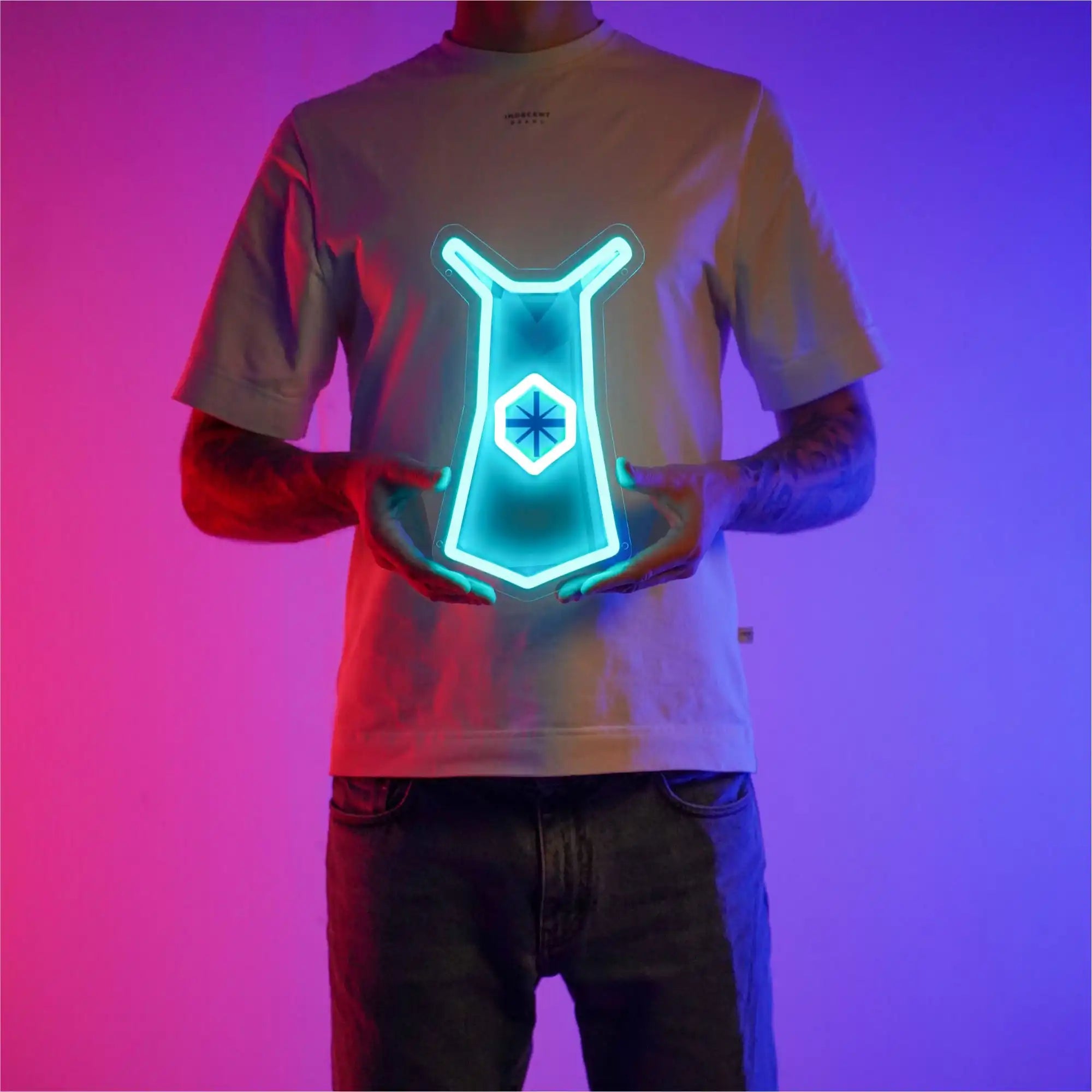 A person proudly displays the Runescape Quest Skillcape LED neon sign, featuring the iconic Quest Skillcape from the game. This LED neon sign represents achievement and completion in Old School RuneScape. A symbol of perseverance and accomplishment, it adds a touch of triumph to any gaming space.