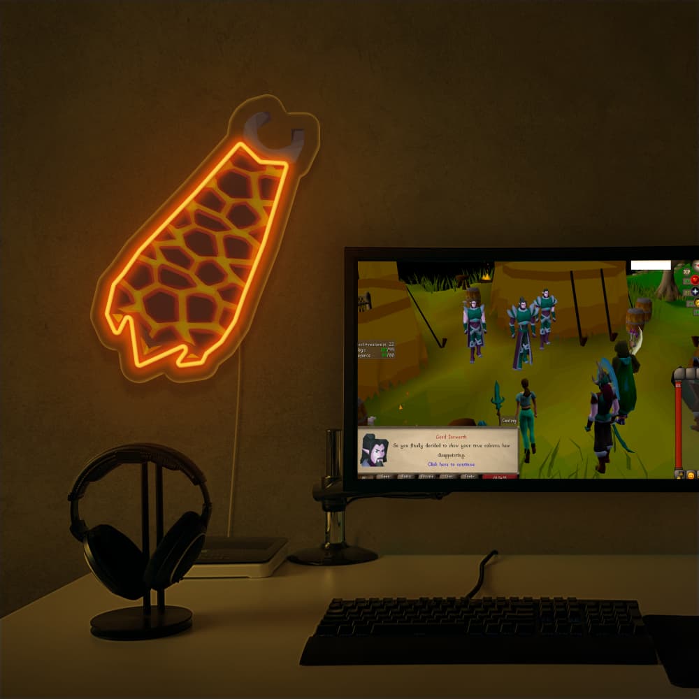 The Runescape Infernal Cape LED neon sign proudly sits next to a gaming PC, symbolizing the dedication and skill required to achieve the Infernal Cape in Old School RuneScape. A unique gift for RS enthusiasts seeking a challenge.