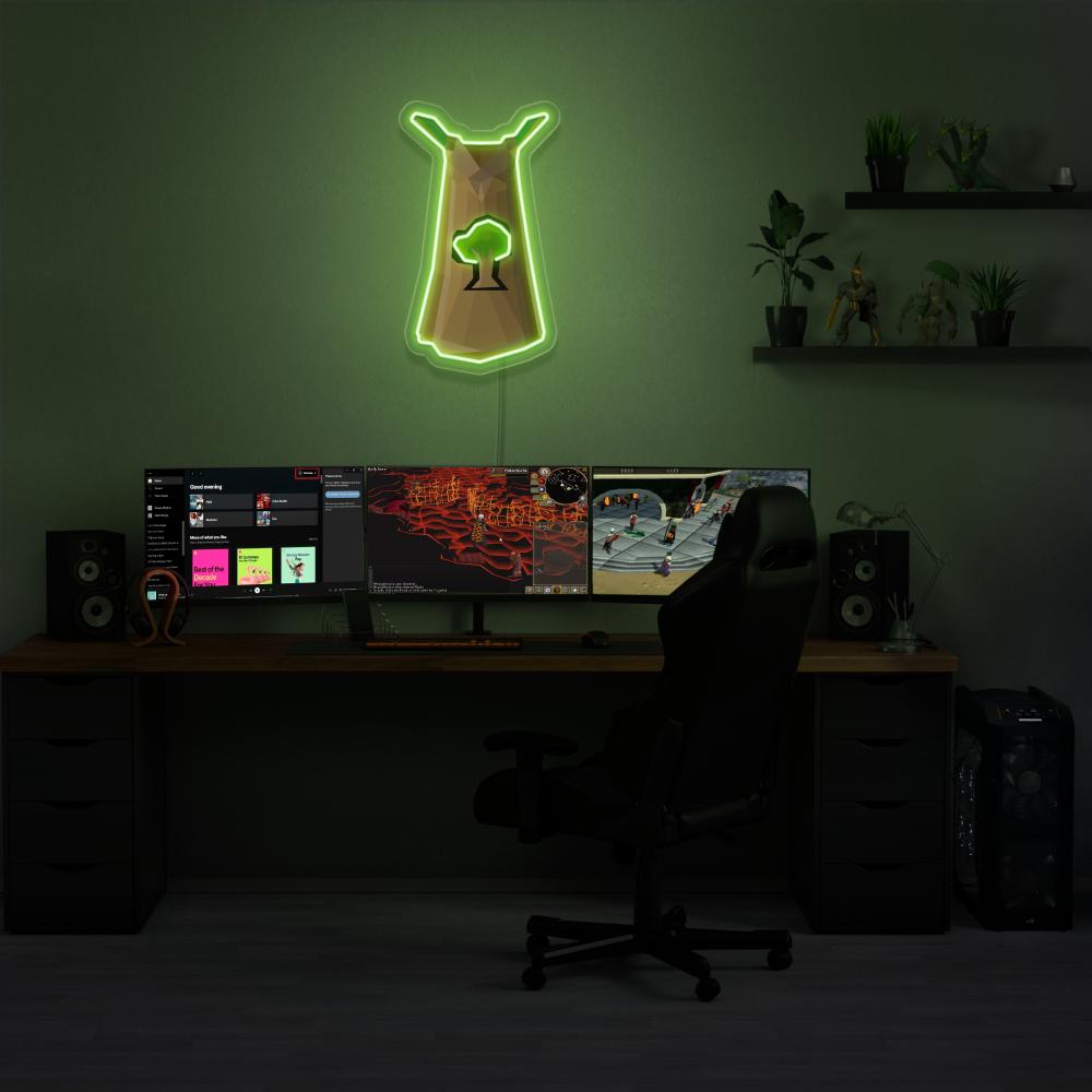 Illuminate your gaming setup with the Runescape Woodcutting Skillcape LED neon sign mounted above a gaming PC. The Woodcutting Skillcape represents the dedication and mastery of woodcutters in RuneScape. A perfect addition to the room, this LED neon sign enhances the ambiance for RuneScape enthusiasts. 