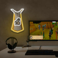 OSRS Construction cape neon sign shaped above a computer setup with a game displayed.