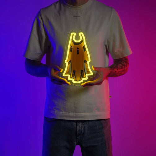 A person proudly displays the Massori Max Cape LED neon sign, featuring the prestigious Max Cape from the game. This LED neon sign represents the pinnacle of achievement and skill in Old School RuneScape. A symbol of dedication and excellence, it adds a touch of prestige to any gaming space. 