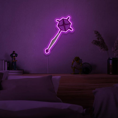 Immerse yourself in the world of magic with the OSRS Ancient Staff LED neon sign mounted above a sleeping bed. This LED neon sign, featuring the iconic ancient staff from Old School RuneScape, creates a serene and mystical atmosphere for rest and relaxation.