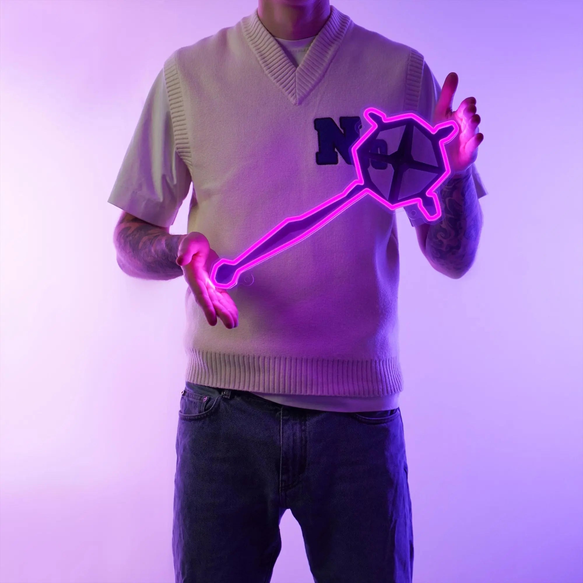 A man holding the OSRS Ancient Staff LED neon sign proudly. This LED neon sign, featuring the iconic ancient staff from Old School RuneScape, adds an aura of ancient allure and mystique to any space.