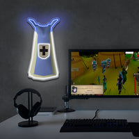RuneScape Defence Skillcape LED neon sign in gaming setup with monitors – OSRS room decor