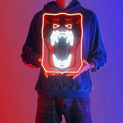 A person proudly showcases the OSRS Dragon Fire Shield LED neon sign, featuring the iconic fire shield symbol from the game. This LED neon sign exudes a sense of power and protection, reminiscent of the fiery battles in RuneScape. This is a unique gift for your RuneScape buddy, evoking nostalgic memories. 