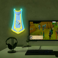 Runescape Fishing Master Cape neon sign of a harp on a wall above a computer setup with a game displayed.