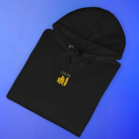 Folded black hoodie with gold OSRS embroidery detail, Old School RuneScape merch clothing apparel and a stylish gift for gamers