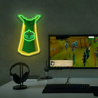 Runescape Herblore cape neon sign shaped like a green and yellow tie above a computer monitor displaying a video game.