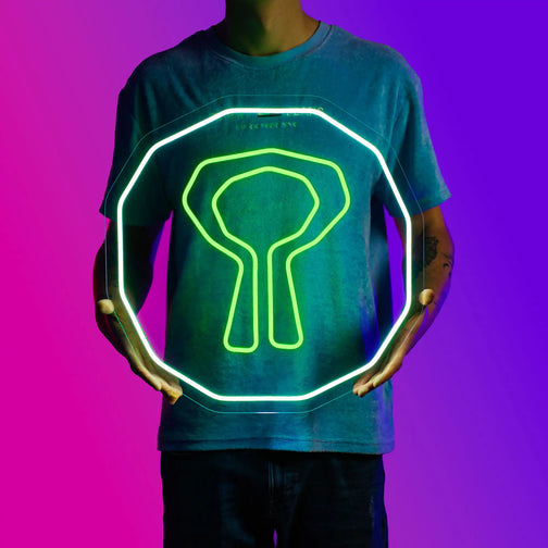 A person proudly displays the OSRS Nature Rune LED neon sign, featuring the iconic Nature Rune from the game. This LED neon sign represents the essence of nature and magic in Old School RuneScape. A symbol of mysticism and power, it adds a touch of enchantment to any gaming space.
