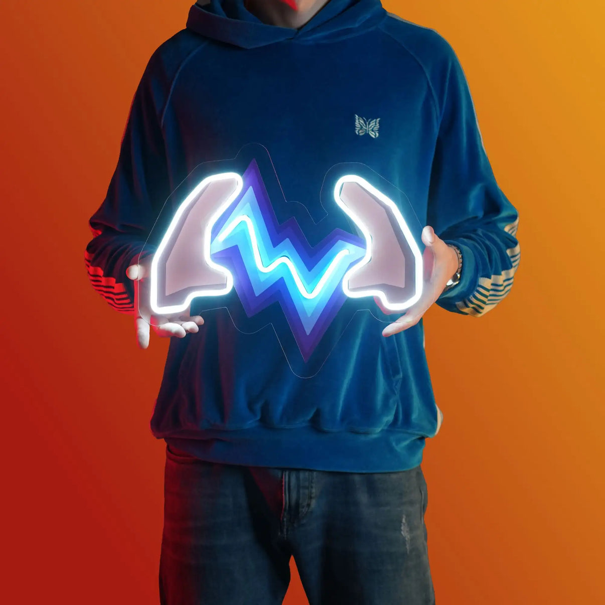A person proudly displays the OSRS Turmoil LED neon sign, featuring the iconic Turmoil prayer from the game. This LED neon sign symbolizes the power and might of the Turmoil prayer in Old School RuneScape. A symbol of spiritual strength and combat prowess, it adds a touch of determination to any gaming space.