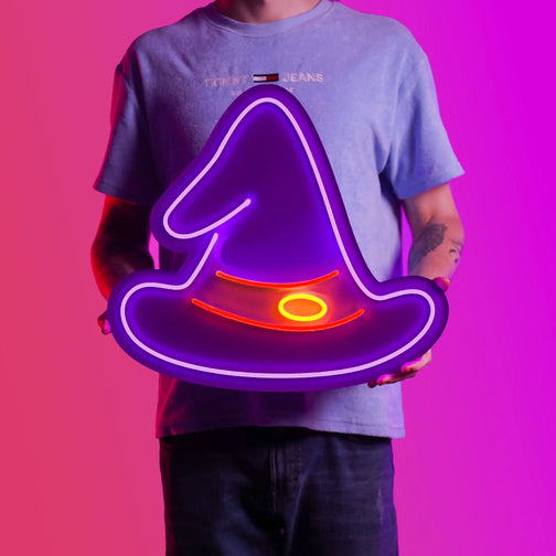 A person proudly displays the OSRS Wizard Hat LED neon sign, featuring the iconic Wizard Hat from the game. This LED neon sign symbolizes the magic and mystique of wizards in Old School RuneScape. A symbol of arcane knowledge and power, it adds a touch of enchantment to any gaming space.
