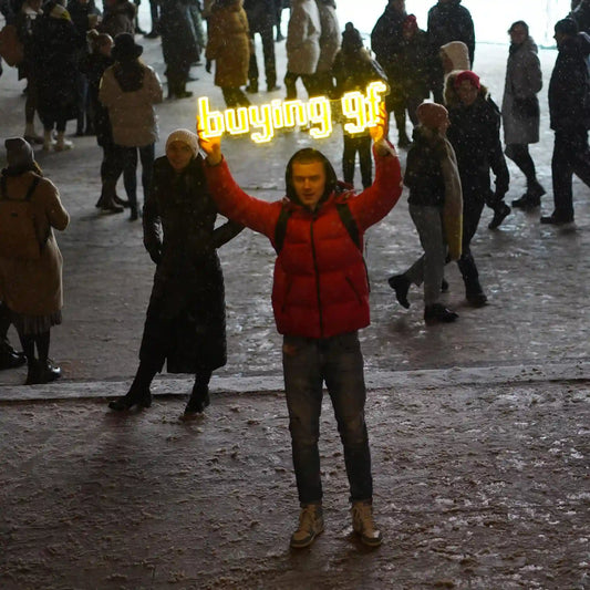 A Runescape enthusiast proudly displays the custom Runescape Buying BF LED neon sign in a public setting, showcasing their passion for the iconic phrase from Old School Runescape.