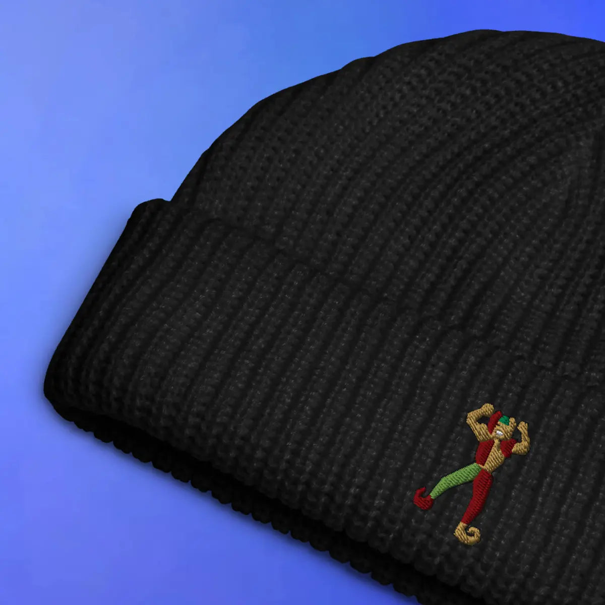 Jester embroidered beanie laid flat with OSRS themed design, Old School RuneScape merch beanie and a playful gift