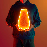 A person proudly showcases the Runescape Fire Cape LED neon sign, featuring the iconic Fire Cape design from the game. This LED neon sign symbolizes achievement and victory in RuneScape, making it an ideal addition to any gaming space. A nostalgic and unique gift for Runescape enthusiasts.