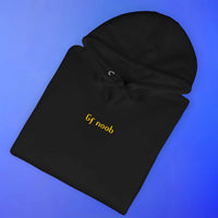 Folded black hoodie with GF noob OSRS embroidery detail, Old School RuneScape merch clothing apparel and a funny gift for gamers