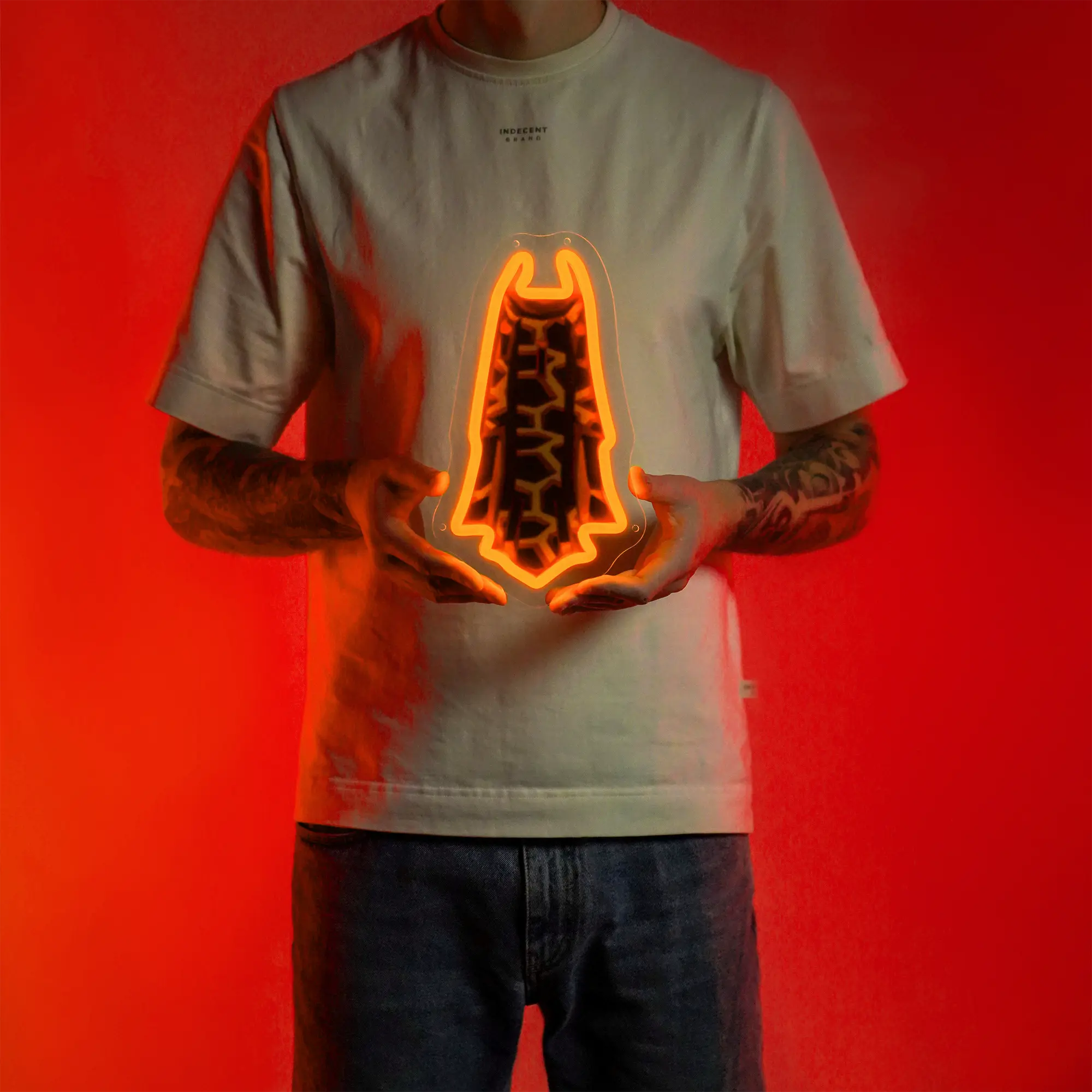 A person proudly displays the Runescape Infernal Max Cape LED neon sign, featuring the prestigious Infernal Max Cape from the game. This LED neon sign represents the pinnacle of achievement and skill in Old School RuneScape. A prestigious and nostalgic gift for RS enthusiasts.