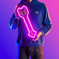 A person proudly displays the Runescape Protect from Range LED neon sign, featuring the protective spell icon from the game. This LED neon sign represents defense and resilience against ranged attacks in Old School RuneScape. A symbol of protection and safety, it adds a touch of security to any gaming space.