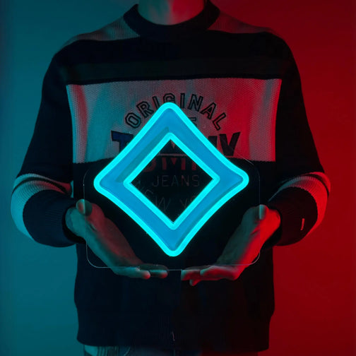 A man proudly holding a LED neon sign of the Seren God Symbol, a divine emblem from Runescape.