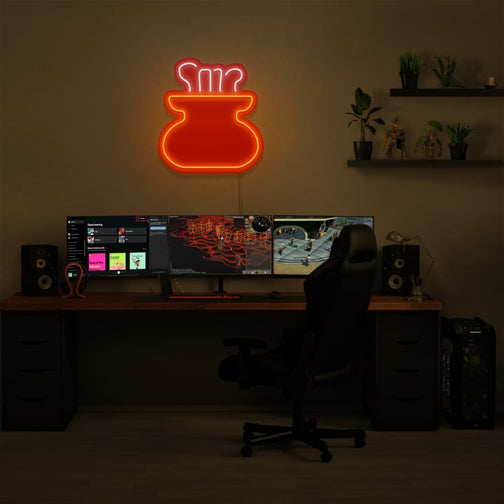 The OSRS Cooking LED neon sign is positioned above a gaming PC, featuring the cooking pot symbol from Old School RuneScape. This LED neon sign adds a nostalgic flair to your gaming setup, reminding players of their culinary adventures in RuneScape.