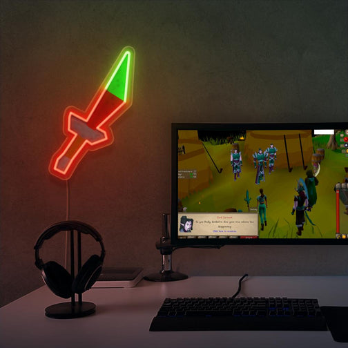 Elevate your gaming space with the OSRS Dragon Dagger LED neon sign positioned near a gaming PC. Featuring the iconic dagger symbol from the game, this LED neon sign adds a touch of adventure to your setup, reminiscent of your exploits in RuneScape. This is a unique gift for your RuneScape buddy, evoking nostalgic memories. 