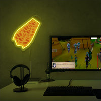 RuneScape Fire Cape LED neon sign next to gaming PC – OSRS setup wall decor