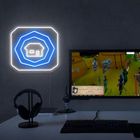 The OSRS Home Tablet LED neon sign sits proudly next to a gaming PC, symbolizing the convenience and practicality of Old School RuneScape. A unique gift for OSRS enthusiasts seeking adventure.