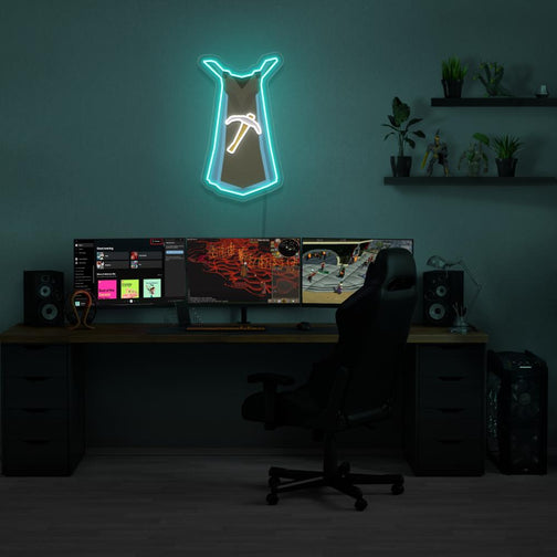 Illuminate your gaming setup with the Runescape Mining Skillcape LED neon sign mounted above a gaming PC. The prestigious Mining Skillcape symbolizes mastery and expertise in mining in Old School RuneScape. A perfect addition to the room, this LED neon sign enhances the ambiance for RS enthusiasts. 