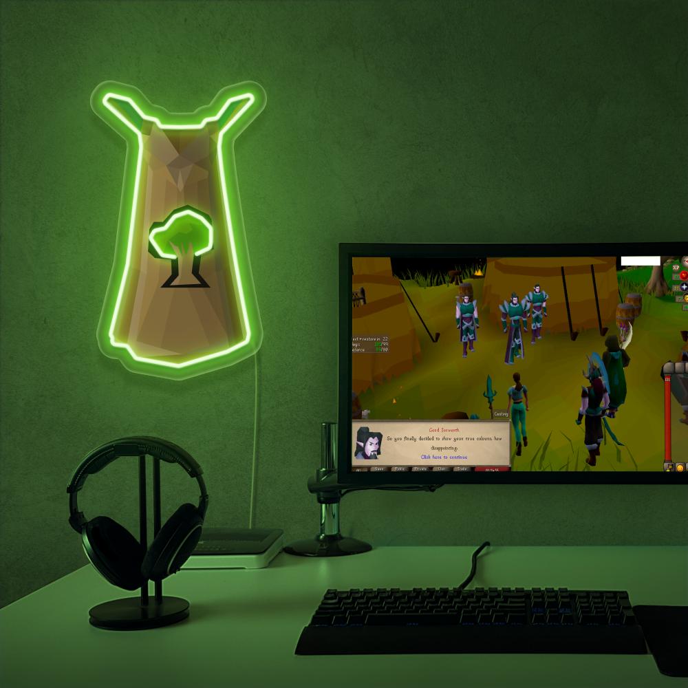 The Runescape Woodcutting Skillcape LED neon sign proudly sits next to a gaming PC, symbolizing the dedication and mastery of woodcutters in RuneScape. An emblem of hard work and perseverance, this LED neon sign adds a touch of rustic charm and nostalgia to any gaming space.